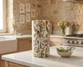 Decorative tissue wrapped roll of Stay Papier paper towels with wildflower floral design on a marble stone kitchen counter.